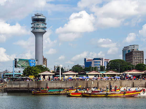 Traders and fishing boats at Kivukoni fish market on the Swahili coast